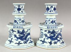 A PAIR OF CHINESE BLUE & WHITE PORCELAIN CANDLESTICKS - each decorated with phoenix and dragons