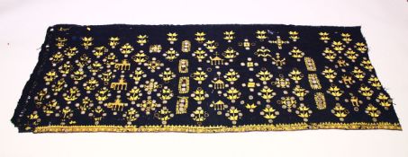 AN INDIAN SUZANI EMBROIDERD TEXTILE, with mirrored roundels, 180cm x 73cm.