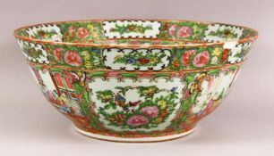 A LARGE 19TH CENTURY CHINESE CANTON FAMILLE ROSE PORCELAIN BOWL - with panel decoration of