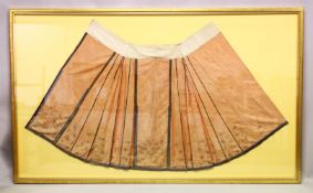 A 19TH CENTURY PALE RED SKIRT, with gold thread embroidered decoration to the lower section,