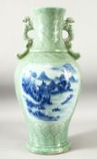 A LARGE CHINESE CELADON TWIN HANDLE VASE, decorated to each side with blue and white panels
