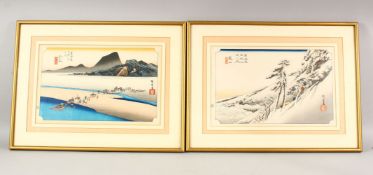 A PAIR OF JAPANESE WOODBLOCK PRINTS - one depicting a snowy mountain scene with figures, the other a