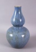 A CHINESE MONOCHROME PALE BLUE GLAZED PORCELAIN GOURD VASE, 20cm high.
