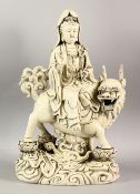 A CHINESE DEHUA PORCELAIN GUANYIN FIGURE - depicting the goddess riding upon the back of kylin,