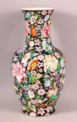 A CHINESE FAMILLE ROSE MILLEFLUER STYLE PORCELAIN VASE, decorated upon a black ground with profuse