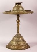 AN ISLAMIC BRASS CANDLESTICK, engraved with bands of calligraphy and decorative motifs, comprised of