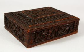 A SMALL EASTERN CARVED WOOD BOX, the interior with fitted compartments, 13.5cm x 11cm.