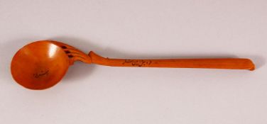 A 19TH CENTURY PERSIAN QAJAR WOODEN SPOON, the bowl and handle with inscription, 21.5cm long.
