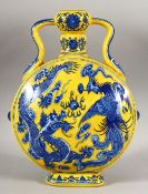 A CHINESE YELLOW GROUND PORCELAIN DRAGON & PHOENIX MOON FLASK - with twin handles, the base with a