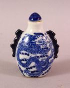 A CHINESE BLUE AND WHITE TWIN HANDLED PORCELAIN SNUFF BOTTLE, painted with dragons, 7cm.