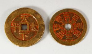 TWO CHINESE CURRENCY COINS - with residual poly chrome decorations 5.6cm & 6cm