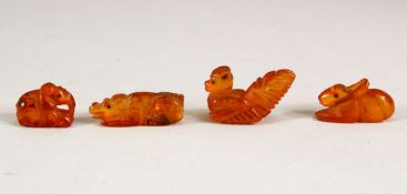 FOUR CHINESE CARVED AMBER MINIATURE ANIMALS, largest 3cm long (4).