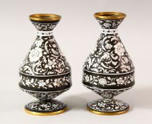 A PAIR OF ISLAMIC BLACK GROUND ENAMEL VASES, each decorated with a black ground and white raised