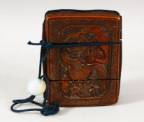 A JAPANESE WOOD INRO, with carved panels depicting squirrel and dog, 9cm x 7cm.