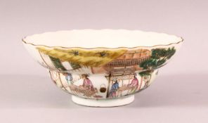 A CHINESE FAMILLE VERTE PORCELAIN BOWL, the sides painted with script and scenes of figures carrying