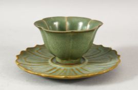 A CHINESE CELADON TEA CUP AND SAUCER, the cup 8.5cm diameter, the saucer 13.5cm diameter.