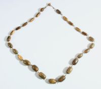 A HORN BEAD NECKLACE, possibly rhino horn, comprising 26 graduating beads, largest bead approx