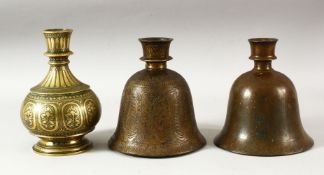 THREE INDIAN BRASS HUQQA BASES, each with engraved / chased decoration, tallest 17.5cm (3).