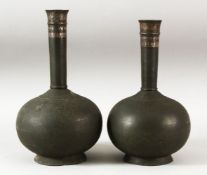 A PAIR OF INDIAN BIDRI BOTTLES, the upper neck with silver inlay, each approx. 26.5cm.
