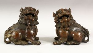 A PAIR OF CHINESE BRONZE CENSERS modelled as kylins, 15cm high.