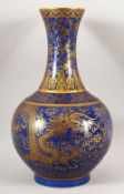 A CHINESE BLUE GROUND BULBOUS VASE, decorated with dragons and scrolls in gilt, six character mark
