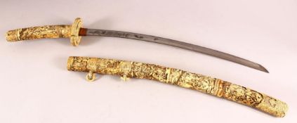 A LARGE JAPANESE MEIJI PERIOD CARVED SECTIONAL IVORY KATANA - carved in relief depicting many