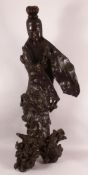 A LARGE 18TH CENTURY CHINESE ROOT WOOD CARVING OF GUANYIN, on a naturalistic root base, 101cm high.