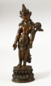 A SMALL INDIAN BRONZE FIGURE OF A DEITY, the head dress inset with small turquoise beads, fixed upon