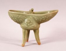 A CHINESE CELADON PORCELAIN ZHUN CUP / LIBATION STYLE CUP, stood on four feet, with moulded floral