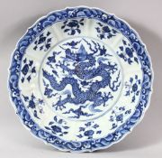 A GOOD LARGE CHINESE BLUE AND WHITE DRAGON DISH, the centre painted with a dragon amongst stylised