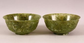 A GOOD PAIR OF CHINESE JADE BOWLS, the sides carved with ho-ho birds and stylised clouds, 15.5cm