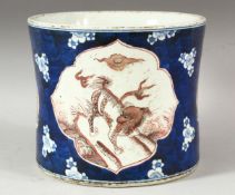 A LARGE CHINESE BLUE AND IRON RED BRUSH POT, decorated with panels of kylin, the base with six