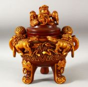 A CHINESE RED AND GILT LACQUERED WOOD TRIPOD CENSER AND COVER, with twin handles and handle rings,