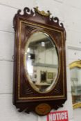 A Georgian style inlaid and carved mahogany fretwork framed mirror.