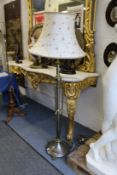 A brass and lacquered steel classical style floor standing lamp.