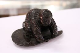 A small Chinese bronze kneeling figure.