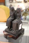 An Egyptian revival paperweight modelled as two seated figures.