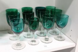 Twelve early 20th century green glass drinking glasses.