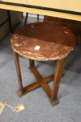 An Art Nouveau circular occasional table with embossed copper top.