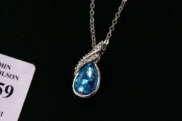 A decorative pendant and chain, boxed.