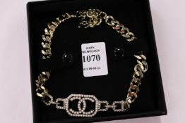 A decorative choker inset with pearls.