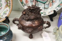 A Chinese bronze censer, the cover with dragon decoration.