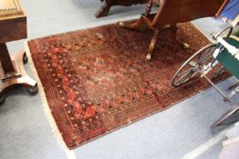 A Persian Bokhara rug.