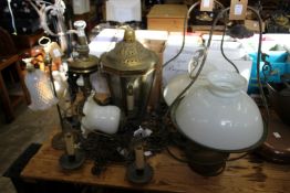 A quantity of various lighting to include a wrought iron chandelier.