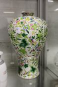 A large Chinese Meiping porcelain vase decorated with flowers and foliage.