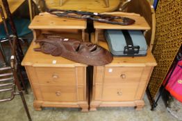 A pair of stained pine bedside chests.