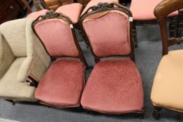 A pair of Victorian carved rosewood and upholstered salon chairs.