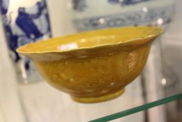 A Chinese gold ground circular porcelain bowl with incised decoration.