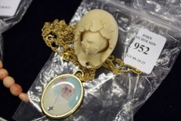 Two decorative pendants and chains.