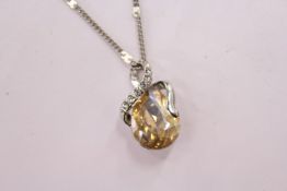 A decorative pendant and chain, boxed.